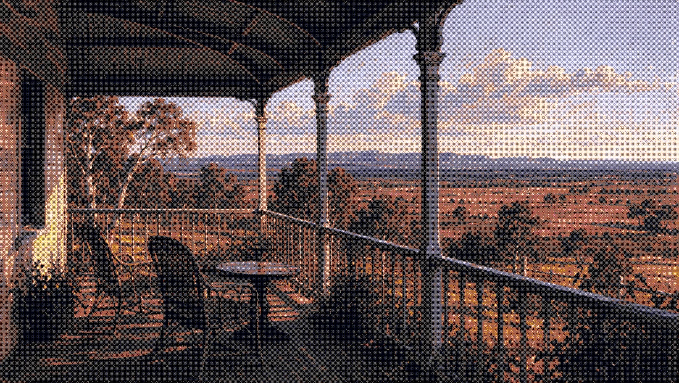 a farmhouse verandah with two chairs already pulled out