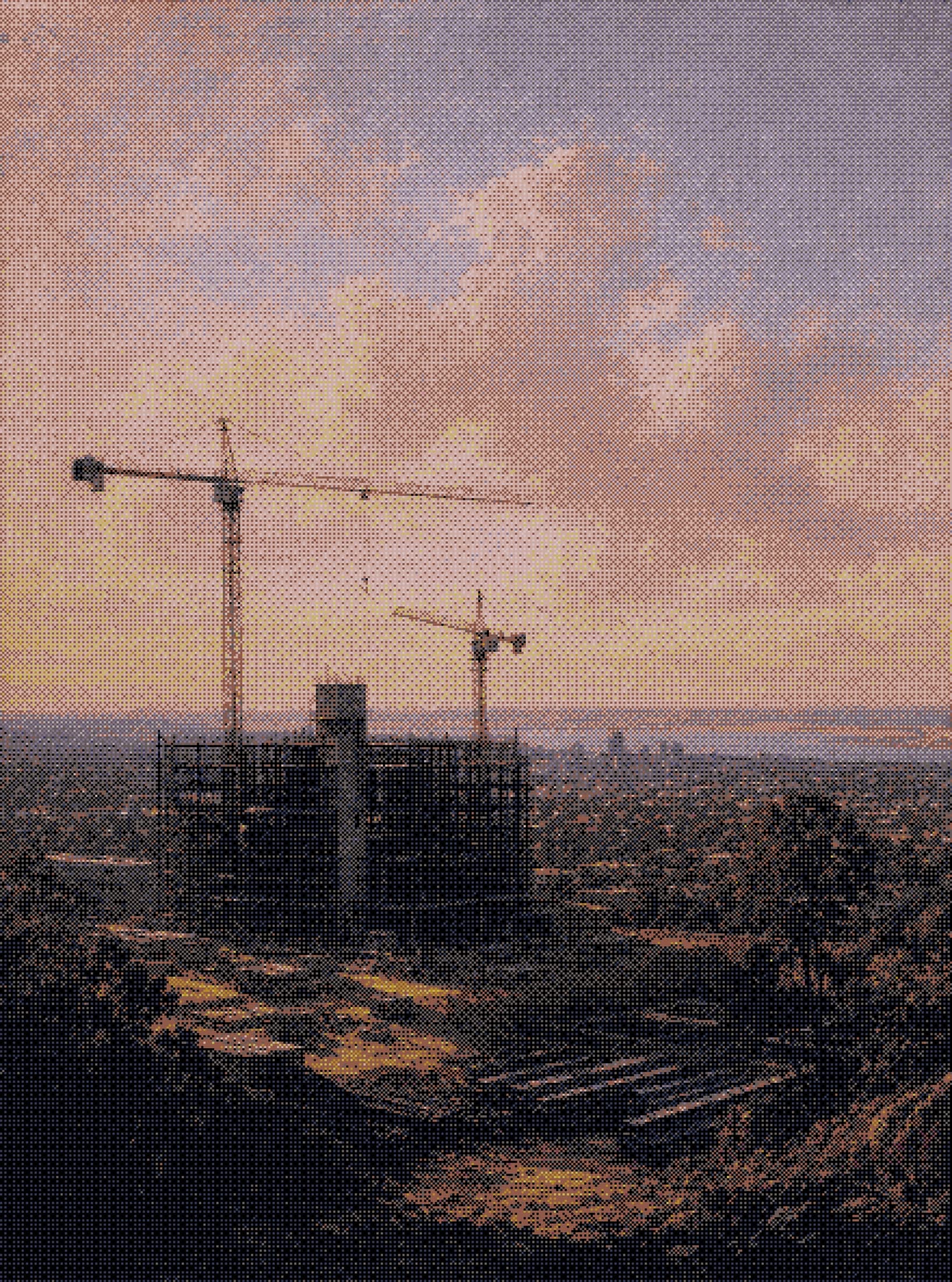 tower cranes over a half-built concrete frame on a ridge, the coast beyond